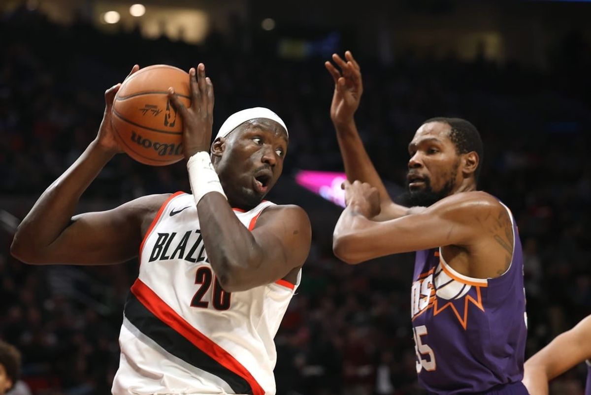 Dec 19, 2023; Portland, Oregon, USA;  Portland Trail Blazers center Duop Reath (26) grabs a rebound against Phoenix Suns forward Kevin Durant (35) in the first half at Moda Center.