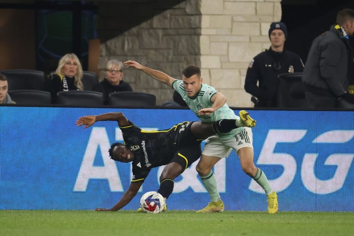 Nov 12, 2023; Columbus, Ohio, USA;  Columbus Crew midfielder Yaw Yeboah (14) is challenged by Atlanta United FC defender Brooks Lennon (11) during the second half at Lower.com Field.