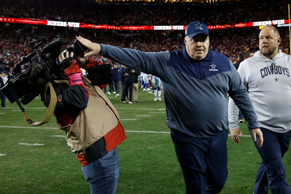Mike McCarthy shoves away a cameraman after his overrated team lost to the 49ers.