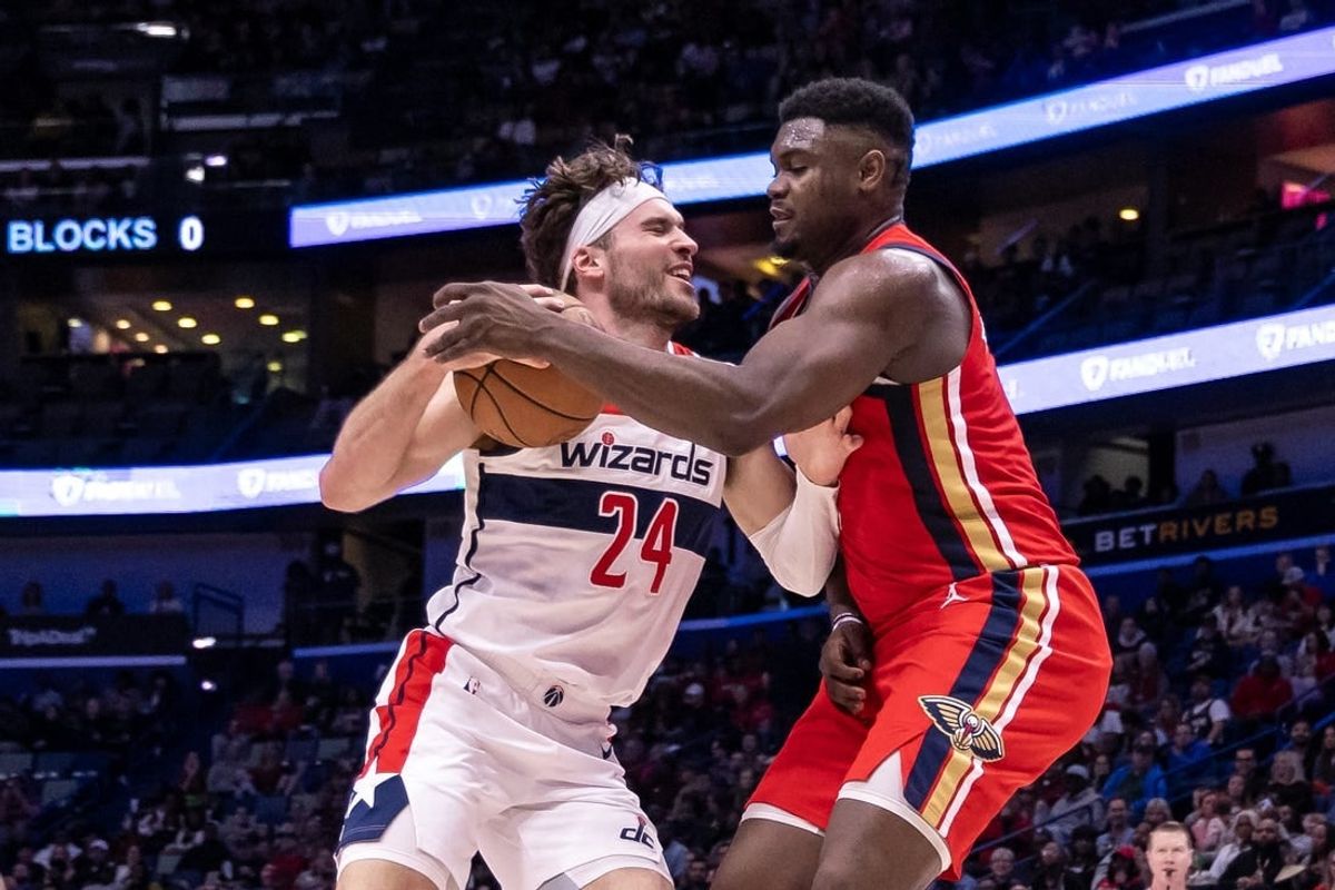 Feb 14, 2024; New Orleans, Louisiana, USA;  Washington Wizards forward Corey Kispert (24) dribbles against New Orleans Pelicans forward Zion Williamson (1) during the first half at Smoothie King Center.