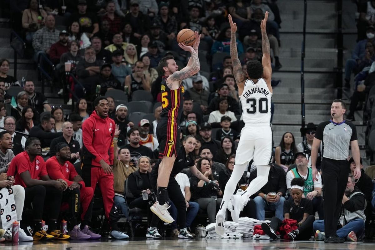 Nov 30, 2023; San Antonio, Texas, USA;  Atlanta Hawks guard Garrison Mathews (25) shoots over San Antonio Spurs forward Julian Champagnie (30) in the first half at the Frost Bank Center.