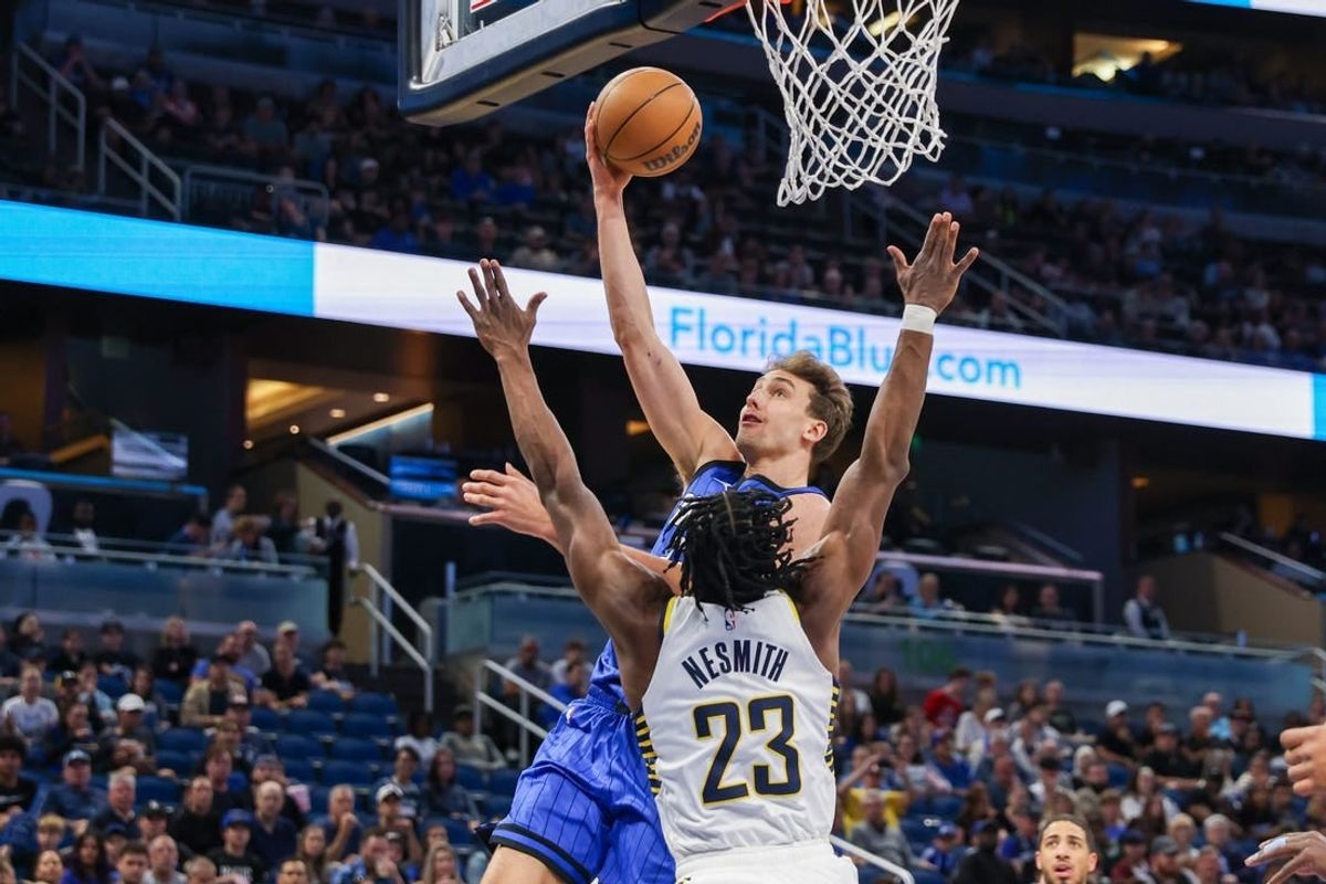 Mar 10, 2024; Orlando, Florida, USA; Orlando Magic forward Franz Wagner (22) goes to the basket against Indiana Pacers forward Aaron Nesmith (23) during the first quarter at KIA Center.