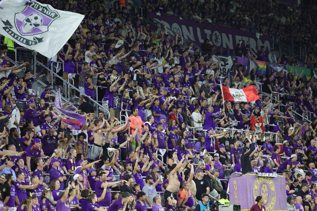 Oct 30, 2023; Orlando, Florida, USA; Orlando City fans celebrate in the second half against the Nashville SC of game one in a round one match of the 2023 MLS Cup Playoffs at Exploria Stadium.