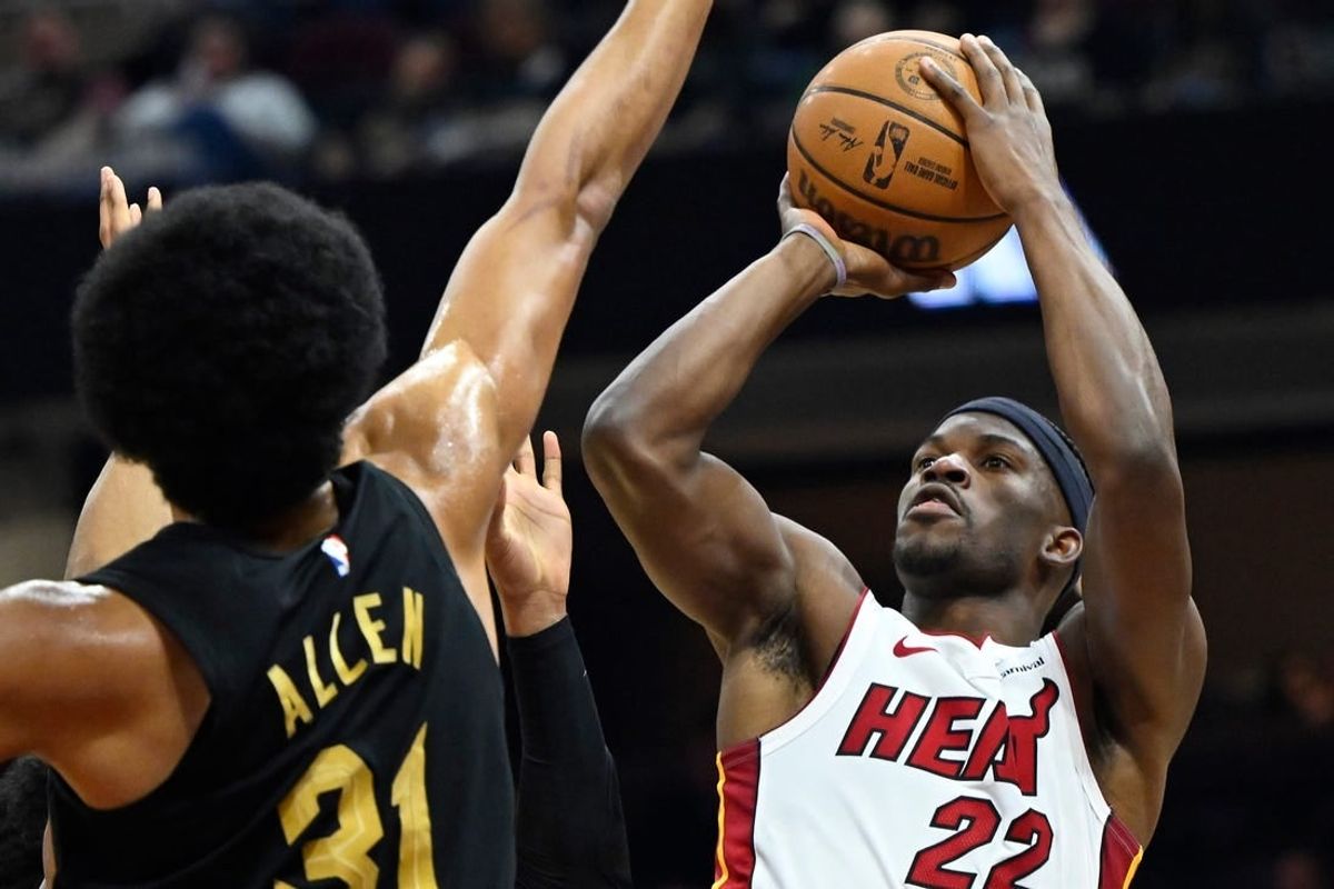 Mar 20, 2024; Cleveland, Ohio, USA; Miami Heat forward Jimmy Butler (22) shoots beside Cleveland Cavaliers center Jarrett Allen (31) in the second quarter at Rocket Mortgage FieldHouse.