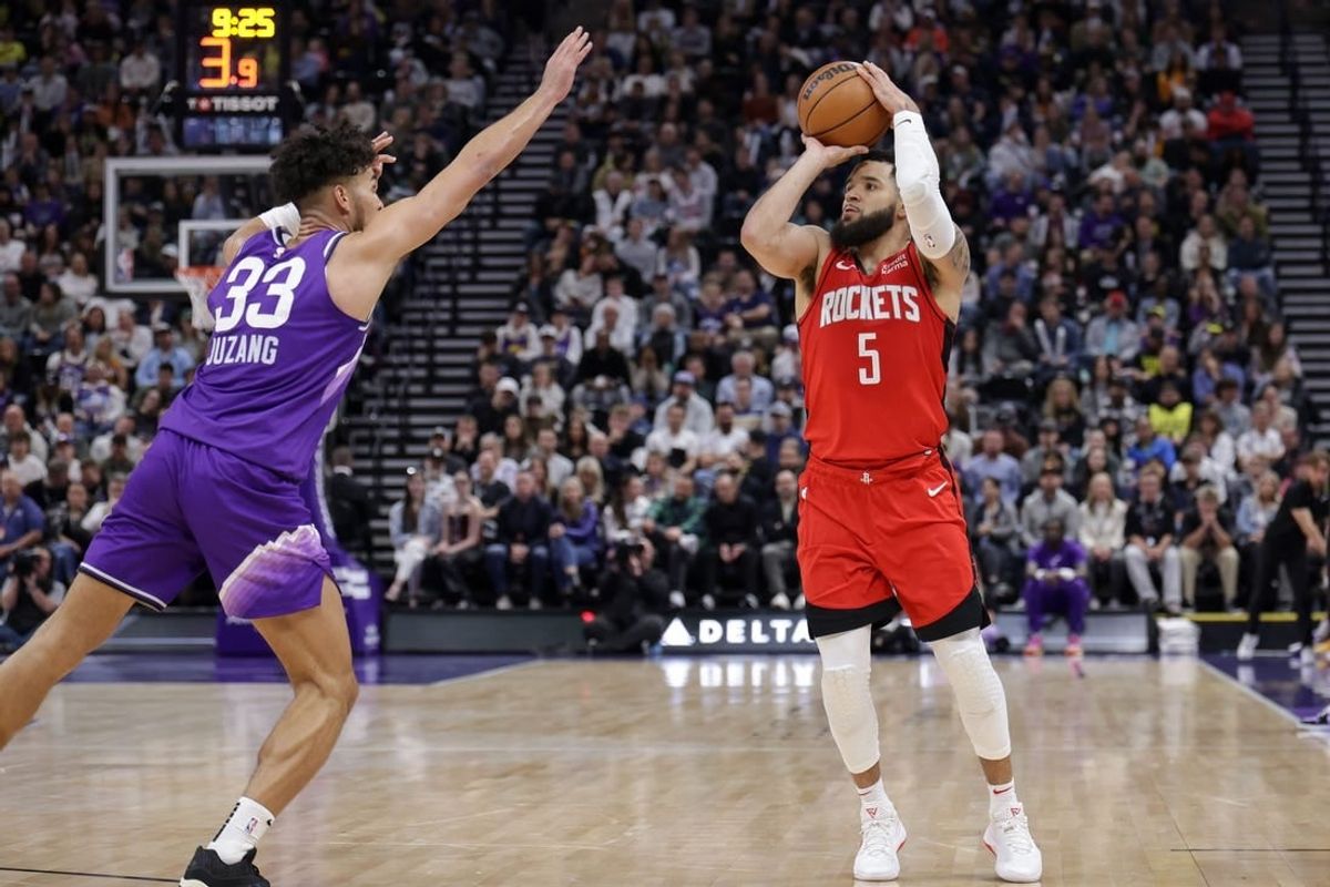 Mar 29, 2024; Salt Lake City, Utah, USA;  Houston Rockets guard Fred VanVleet (5) shoots a three point shot over Utah Jazz guard Johnny Juzang (33) during the second half at Delta Center.
