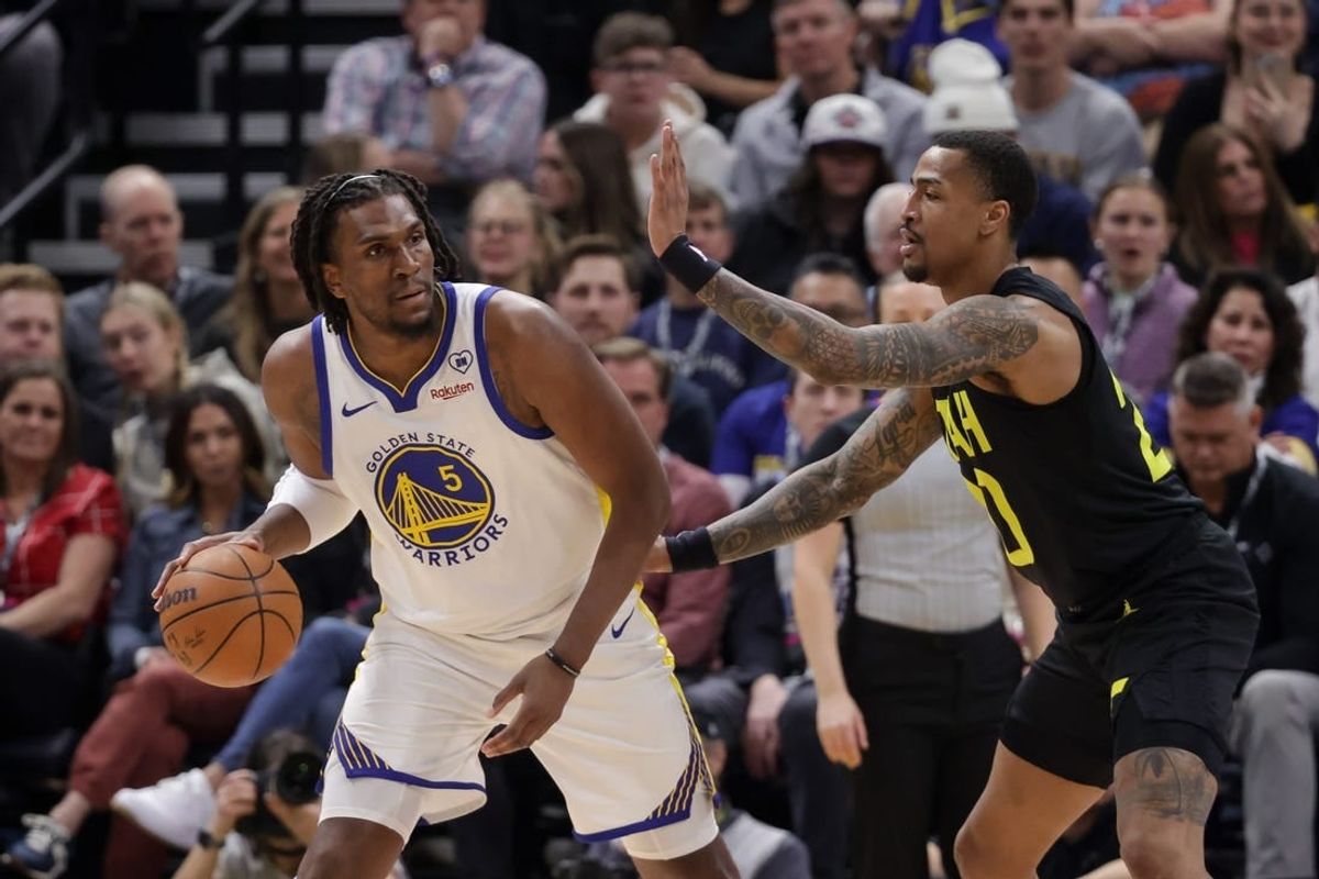 Feb 12, 2024; Salt Lake City, Utah, USA;  Golden State Warriors forward Kevon Looney (5) controls the ball from Utah Jazz forward John Collins (20) during the first quarter at Delta Center.