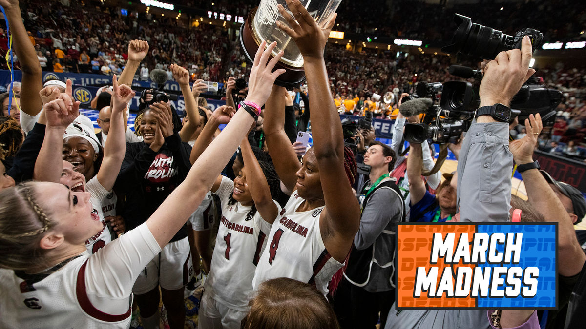 South Carolina’s Aliyah Boston holds up the championship trophy after defeating Tennessee 74-58 to win the SEC Tournament.