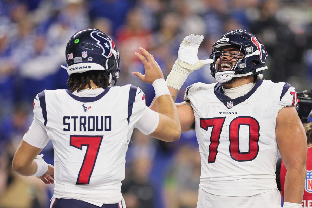 C.J. Stroud and Juice Scruggs celebrate a touchdown pass during the second quarter against the Indianapolis Colts at Lucas Oil Stadium.