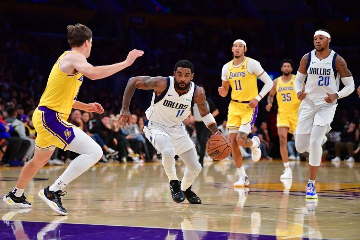 Nov 22, 2023; Los Angeles, California, USA; Dallas Mavericks guard Kyrie Irving (11) moves to the basket against Los Angeles Lakers guard Austin Reaves (15) during the first half at Crypto.com Arena.