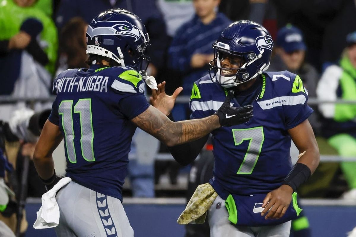Nov 12, 2023; Seattle, Washington, USA; Seattle Seahawks quarterback Geno Smith (7) celebrates with wide receiver Jaxon Smith-Njigba (11) after throwing a touchdown pass against the Washington Commanders during the fourth quarter at Lumen Field.