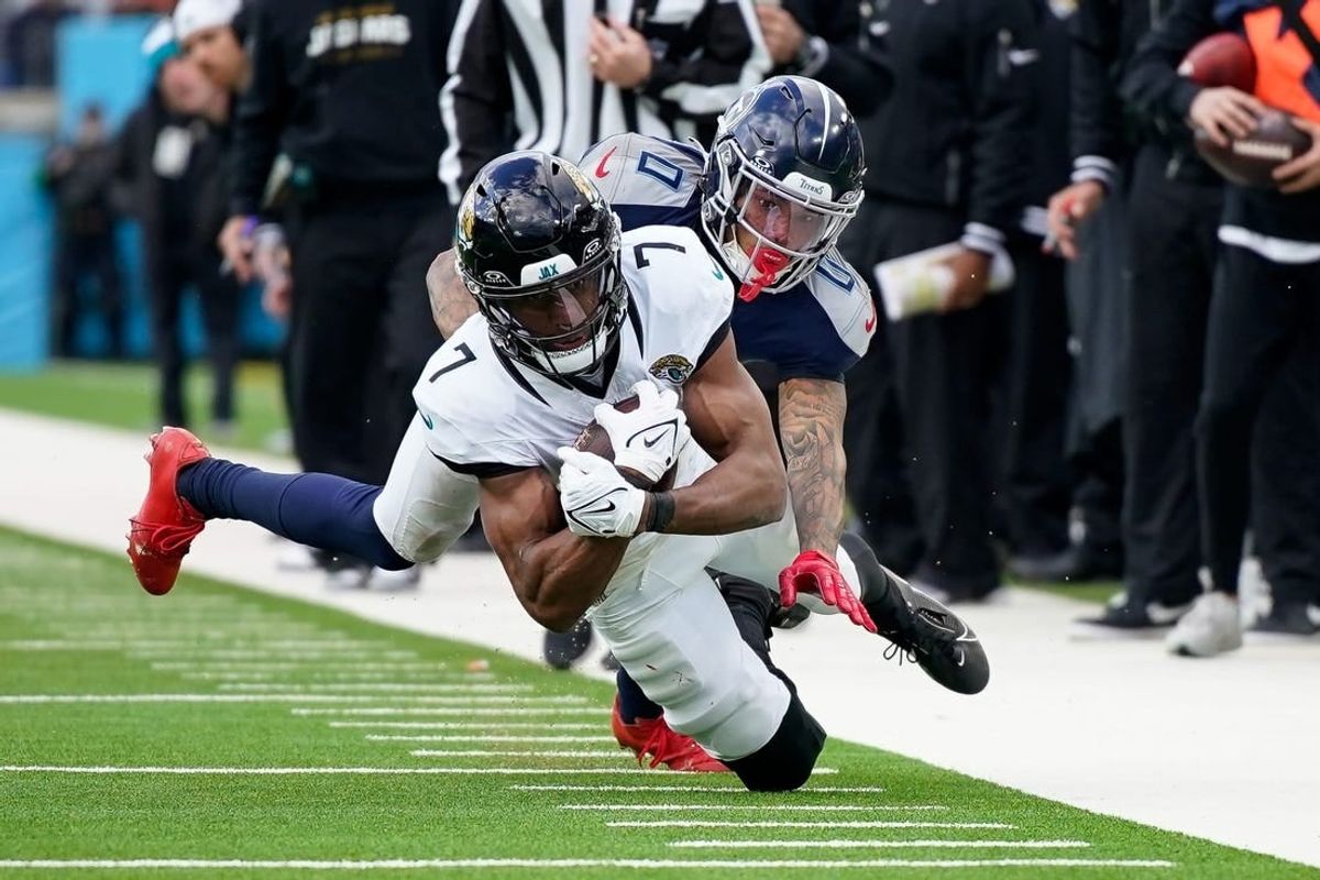 Tennessee Titans cornerback Sean Murphy-Bunting (0) tackles Jacksonville Jaguars wide receiver Zay Jones (7) during the third quarter at Nissan Stadium in Nashville, Tenn., Sunday, Jan. 7, 2024.