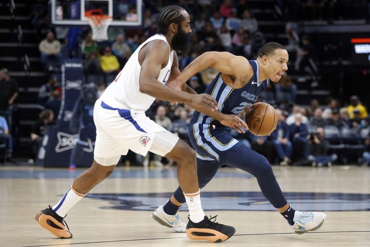 Jan 12, 2024; Memphis, Tennessee, USA; Memphis Grizzlies guard Desmond Bane (22) drives to the basket as Los Angeles Clippers guard James Harden (1) defends during the first half at FedExForum.
