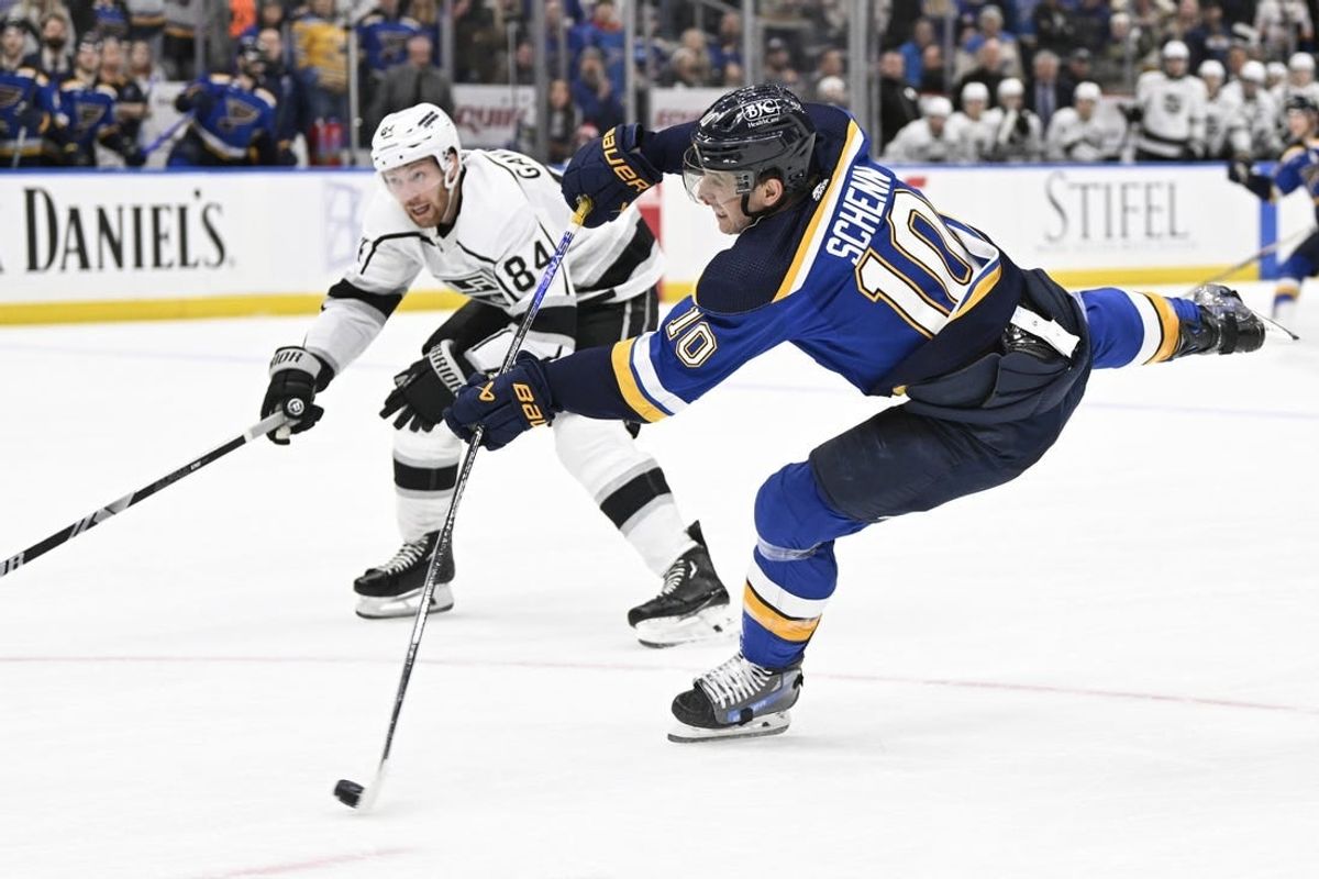 Jan 28, 2024; St. Louis, Missouri, USA; St. Louis Blues center Brayden Schenn (10) takes a shot against the Los Angeles Kings during overtime at Enterprise Center.