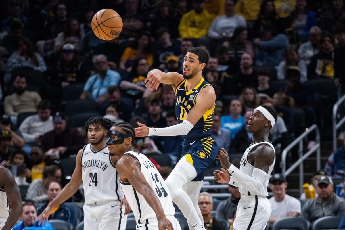 Apr 1, 2024; Indianapolis, Indiana, USA; Indiana Pacers guard Tyrese Haliburton (0) passes the ball while Brooklyn Nets center Nic Claxton (33) defends in the second half at Gainbridge Fieldhouse.
