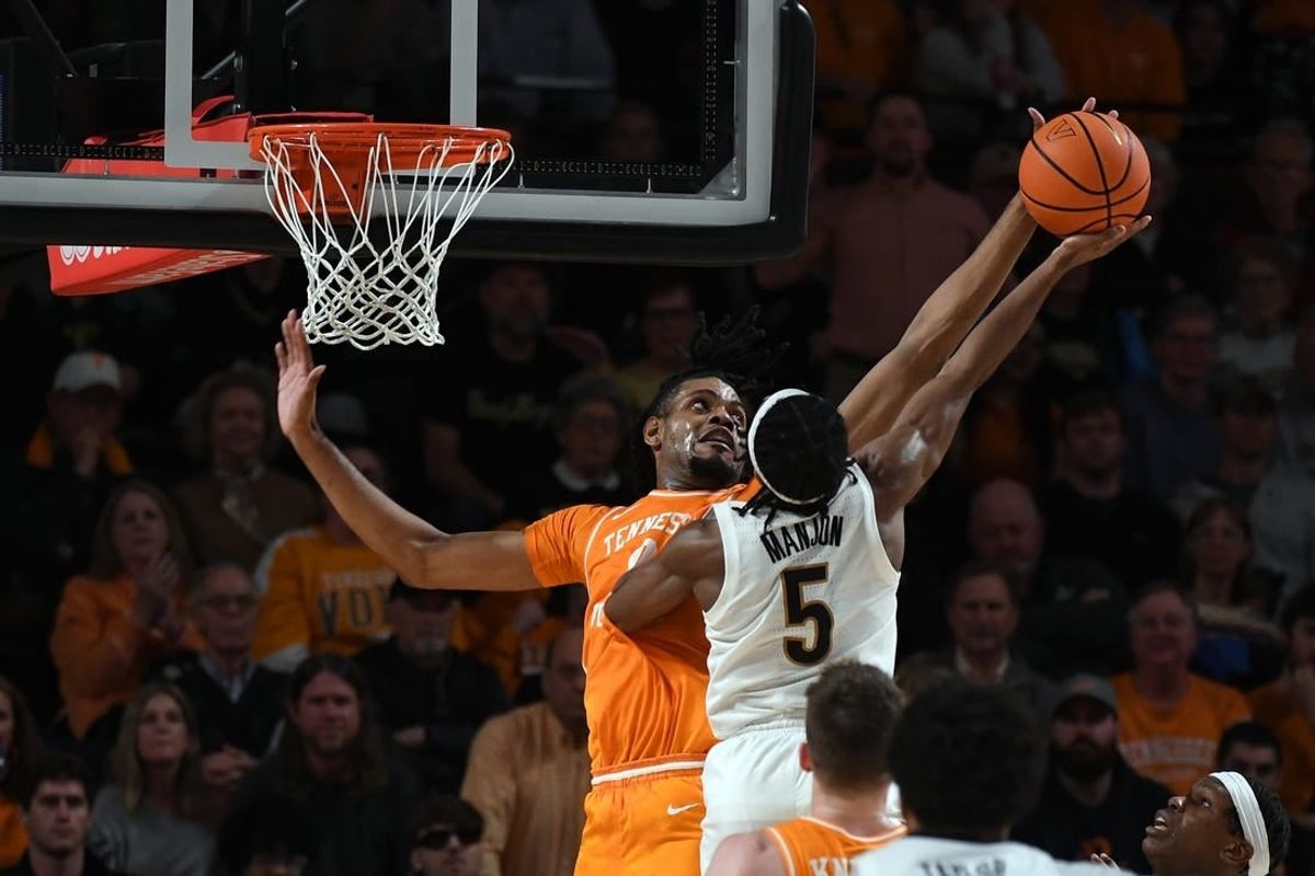 Jan 27, 2024; Nashville, Tennessee, USA; Tennessee Volunteers forward Jonas Aidoo (0) blocks a shot attempt by Vanderbilt Commodores guard Ezra Manjon (5) during the second half at Memorial Gymnasium.