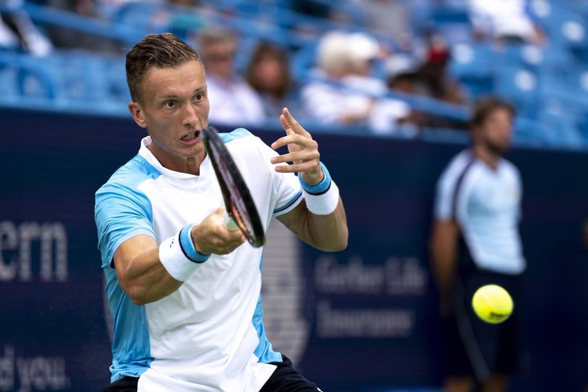 Aug 15, 2023; Mason, OH, USA; Jiri Lehecka, of Czech Republic, hits a return to Taylor Fritz, of the United States, during the Western & Southern Open at Lindner Family Tennis Center.