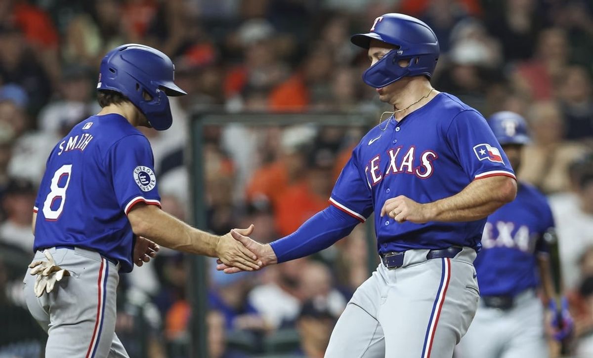 Apr 12, 2024; Houston, Texas, USA; Texas Rangers designated hitter Wyatt Langford (36) celebrates with third baseman Josh Smith (8) after scoring a run during the sixth inning against the Houston Astros at Minute Maid Park.
