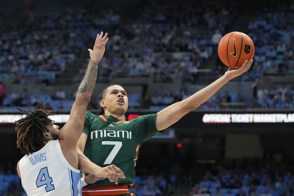 Feb 26, 2024; Chapel Hill, North Carolina, USA; Miami (Fl) Hurricanes guard Kyshawn George (7) shoots as North Carolina Tar Heels guard RJ Davis (4) defends in the first half at Dean E. Smith Center.