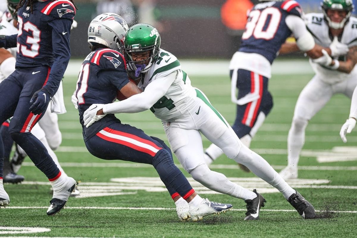 Sep 24, 2023; East Rutherford, New Jersey, USA; New England Patriots wide receiver Demario Douglas (81) is tackled by New York Jets cornerback Justin Hardee (34) during the first half at MetLife Stadium.