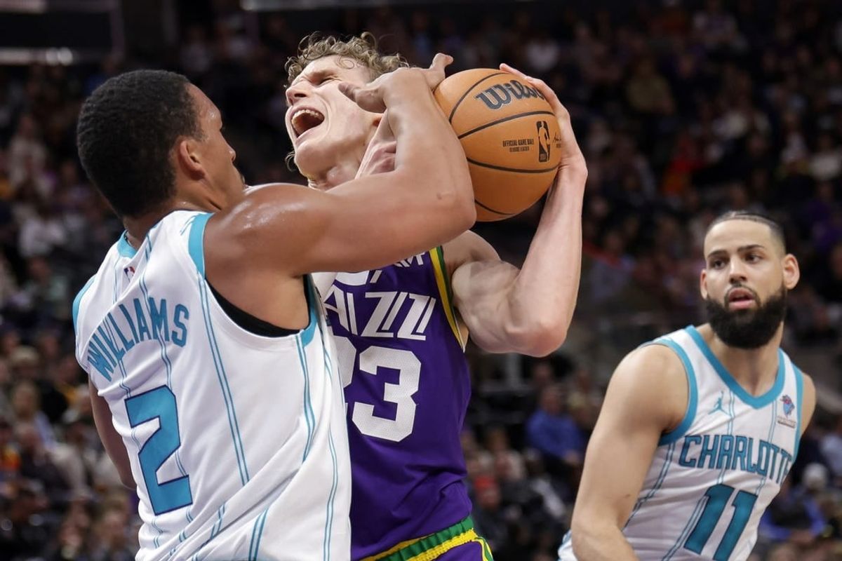 Feb 22, 2024; Salt Lake City, Utah, USA;  Utah Jazz forward Lauri Markkanen (23) is fouled by Charlotte Hornets forward Grant Williams (2) during the second quarter at Delta Center.