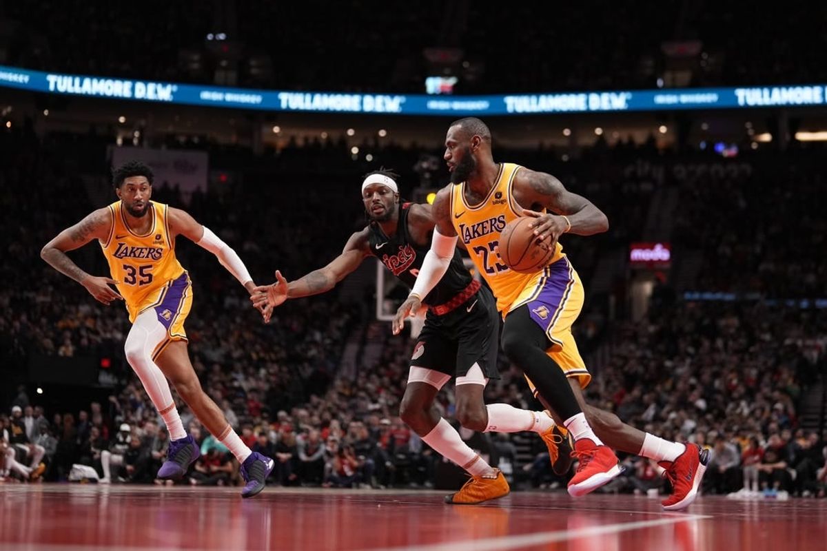 Nov 17, 2023; Portland, Oregon, USA; Los Angeles Lakers small forward LeBron James (23) dribbles the ball while defended by Portland Trail Blazers small forward Jerami Grant (9) during the second half at Moda Center.