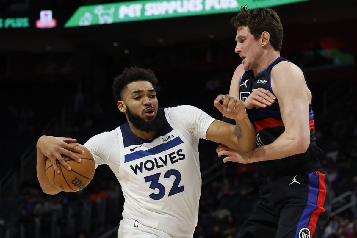 Jan 17, 2024; Detroit, Michigan, USA;  Minnesota Timberwolves center Karl-Anthony Towns (32) is defended by Detroit Pistons forward MikeMuscala (41) in the first half at Little Caesars Arena.
