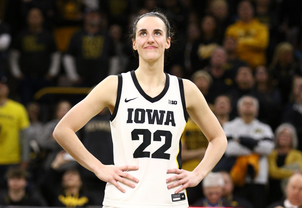 Guard Caitlin Clark of the Iowa Hawkeyes listens as the crowd cheers after breaking the NCAA women’s all-time scoring record during the game against the Michigan Wolverines at Carver-Hawkeye Arena on Feb. 15, 2024.