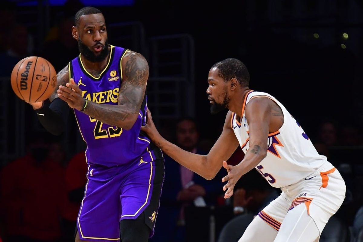 Jan 11, 2024; Los Angeles, California, USA; Los Angeles Lakers forward LeBron James (23) moves the ball against Phoenix Suns forward Kevin Durant (35) during the first half at Crypto.com Arena.
