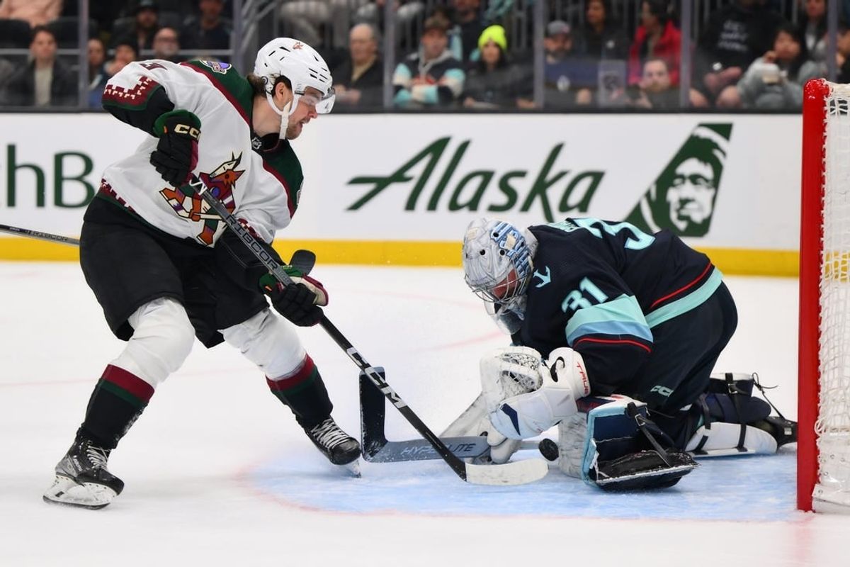 Apr 9, 2024; Seattle, Washington, USA; Seattle Kraken goaltender Philipp Grubauer (31) blocks a goal shot by Arizona Coyotes left wing Matias Maccelli (63) during the first period at Climate Pledge Arena.