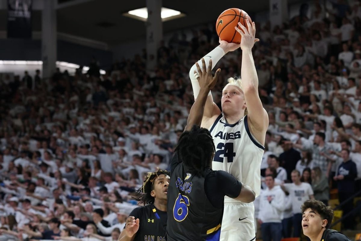 Jan 30, 2024; Logan, Utah, USA; Utah State Aggies forward Karson Templin (24) shoots over San Jose State Spartans guard Latrell Davis (6) during the second half at Dee Glen Smith Spectrum.