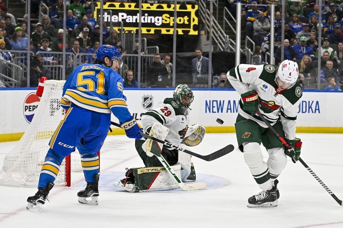Mar 16, 2024; St. Louis, Missouri, USA;  Minnesota Wild goaltender Marc-Andre Fleury (29) and defenseman Jon Merrill (4) defend the net against St. Louis Blues defenseman Matthew Kessel (51) during the second period at Enterprise Center.