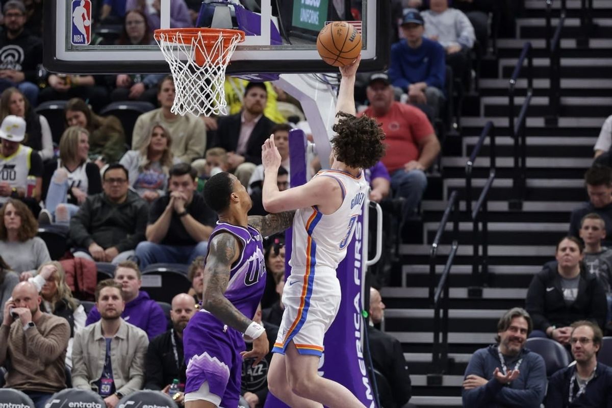 Jan 18, 2024; Salt Lake City, Utah, USA;  Oklahoma City Thunder guard Josh Giddey (3) is fouled by Utah Jazz forward John Collins (20) while shooting the ball during the second half at Delta Center.