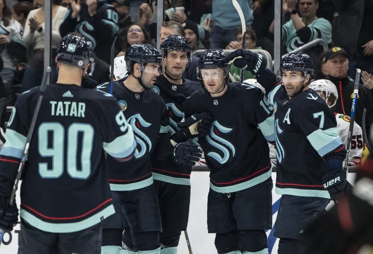 Jan 24, 2024; Seattle, Washington, USA; Seattle Kraken forward Jared McCann (19), second from right, is congratulated by forward Jordan Eberle (7), forward Tomas Tatar (90), defenseman Justin Schultz (4), second from left, and defenseman Brian Dumoulin (8) after scoring a goal against the Chicago Blackhawks during the first period at Climate Pledge Arena.