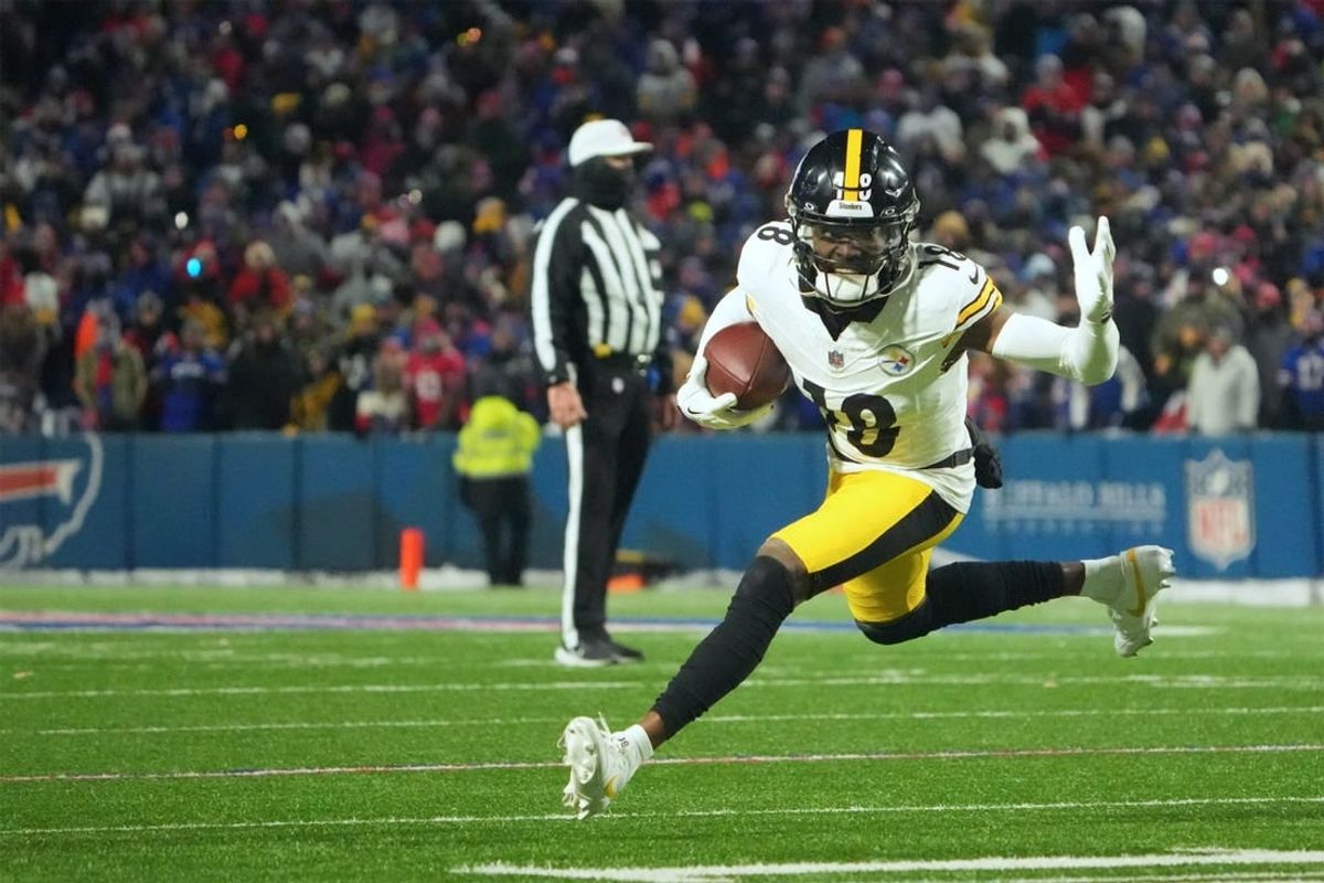 Jan 15, 2024; Orchard Park, New York, USA; Pittsburgh Steelers wide receiver Diontae Johnson (18) runs the ball in the second half against the Buffalo Bills in a 2024 AFC wild card game at Highmark Stadium.