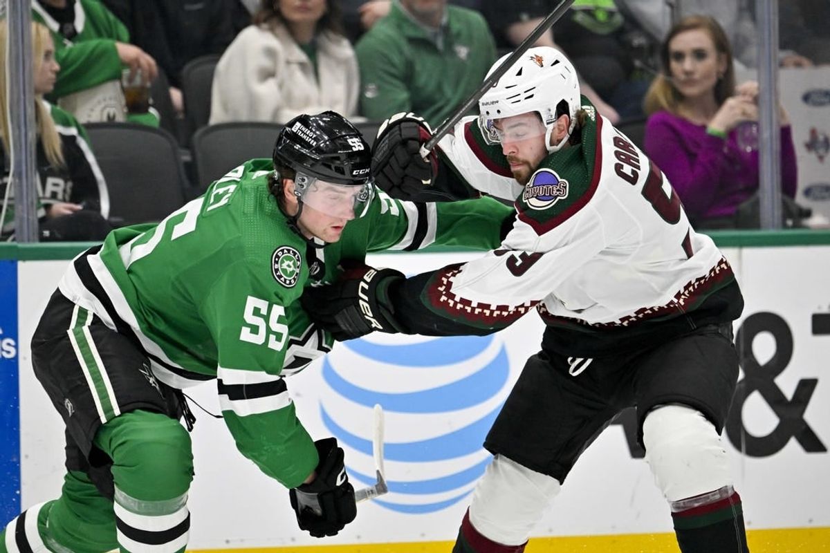 Mar 20, 2024; Dallas, Texas, USA; Arizona Coyotes left wing Michael Carcone (53) tries to skate past Dallas Stars defenseman Thomas Harley (55) during the first period at the American Airlines Center.