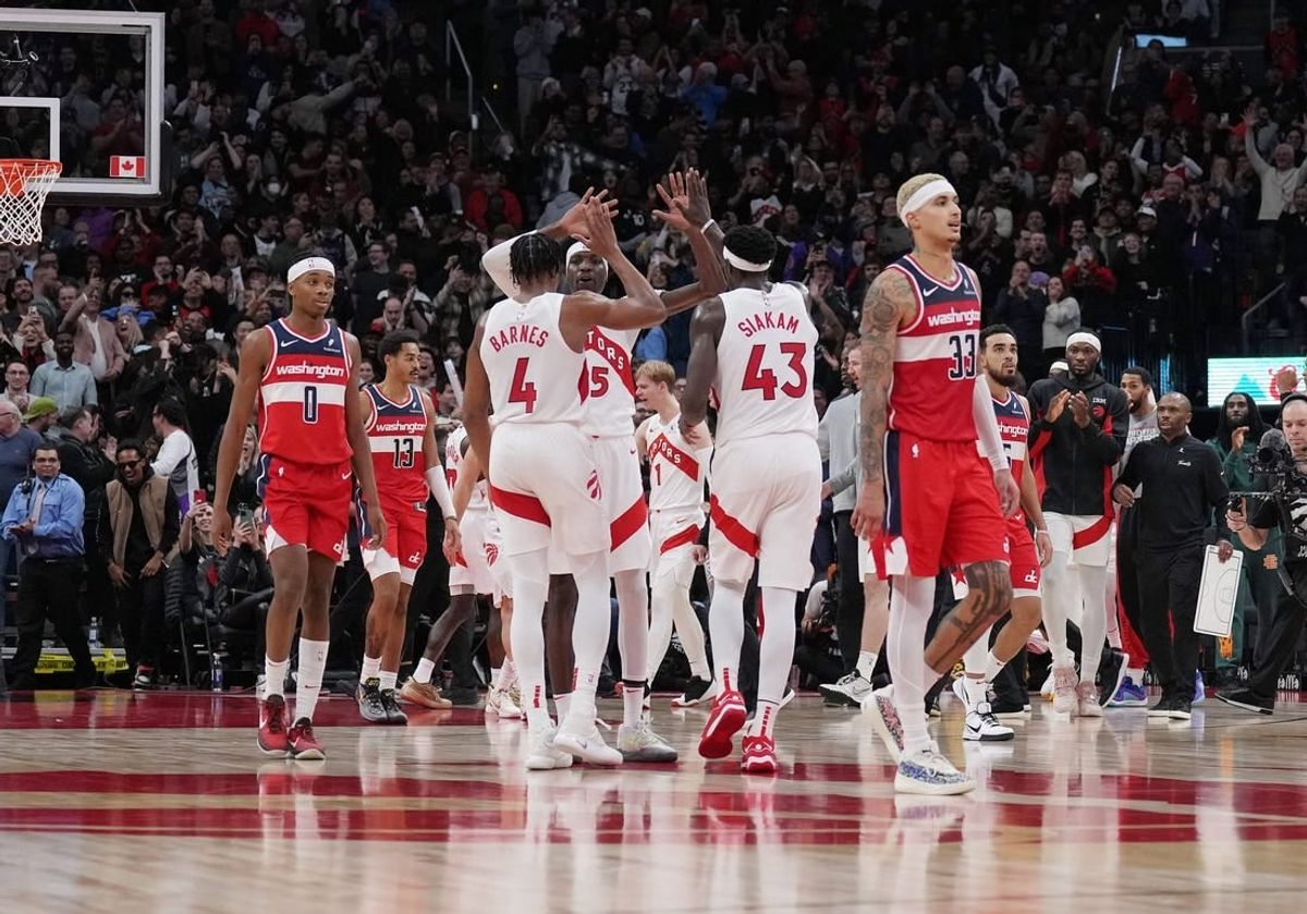 Nov 13, 2023; Toronto, Ontario, CAN; Toronto Raptors forward Pascal Siakam (43), forward Scottie Barnes (4), and forward Chris Boucher (25) celebrate a basket against the Washington Wizards during the fourth quarter at Scotiabank Arena.