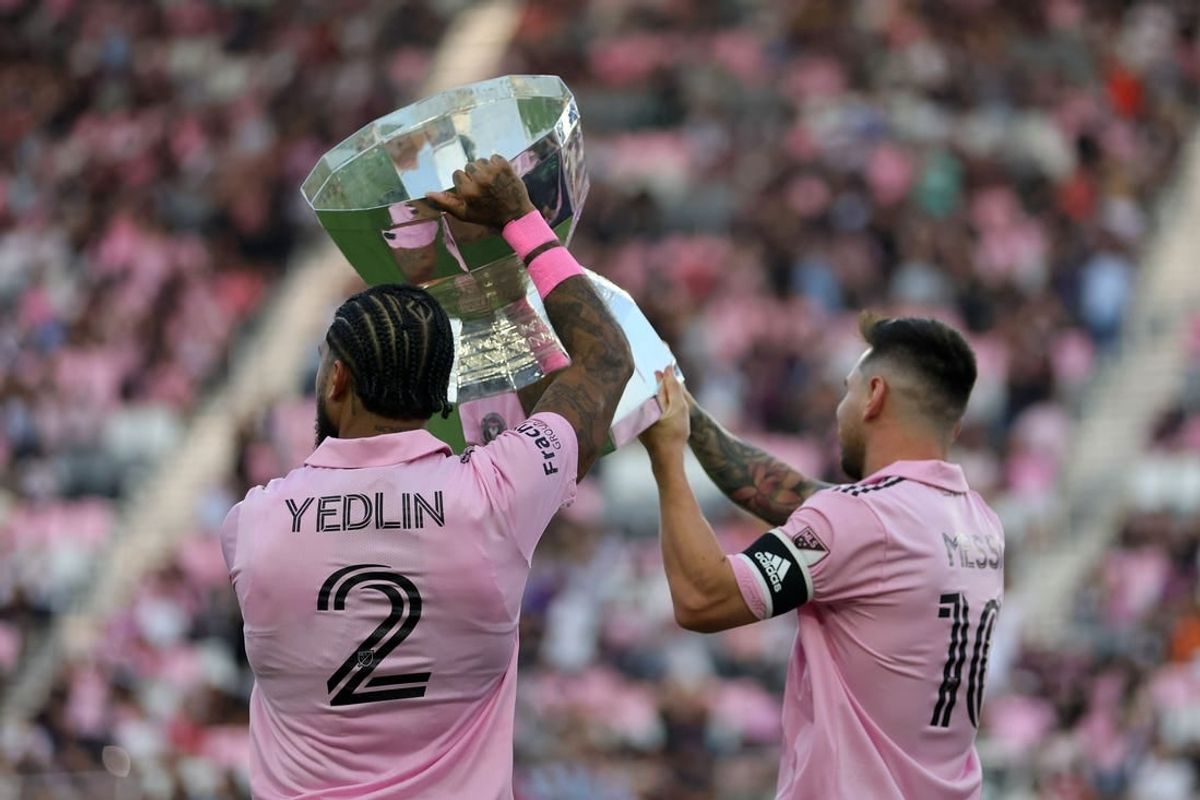 Aug 30, 2023; Fort Lauderdale, Florida, USA; Inter Miami defender DeAndre Yedlin (2) and forward Lionel Messi (10)  hoist the Leagues Cup trophy before the game against Nashville SC at DRV PNK Stadium.