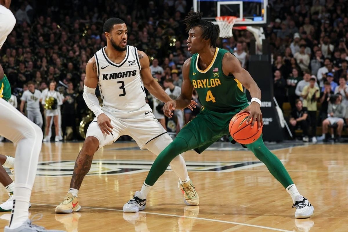 Jan 31, 2024; Orlando, Florida, USA; UCF Knights guard Darius Johnson (3) defends Baylor Bears guard Ja'Kobe Walter (4) during the first half at Addition Financial Arena.