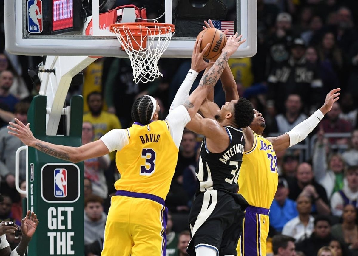 Mar 26, 2024; Milwaukee, Wisconsin, USA; Milwaukee Bucks forward Giannis Antetokounmpo (34) puts up a shot against Los Angeles Lakers forward Anthony Davis (3) and Los Angeles Lakers forward Rui Hachimura (28) in the second overtime at Fiserv Forum.