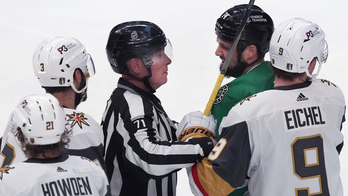 Dallas Stars left wing Jamie Benn is held back by linesman Brad Kovachik and Vegas Golden Knights center Jack Eichel.