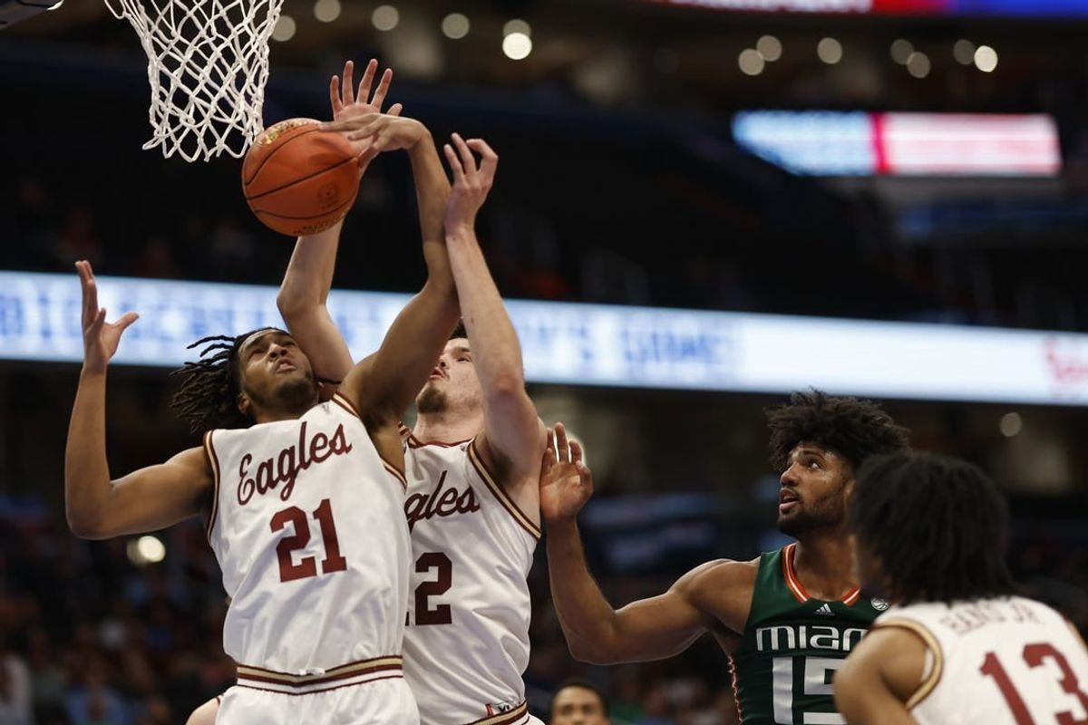 Mar 12, 2024; Washington, D.C., USA; Boston College Eagles forward Devin McGlockton (21) and College Eagles forward Quinten Post (12) reach for a rebound in front of Miami (Fl) Hurricanes forward Norchad Omier (15) in the first half at Capital One Arena.