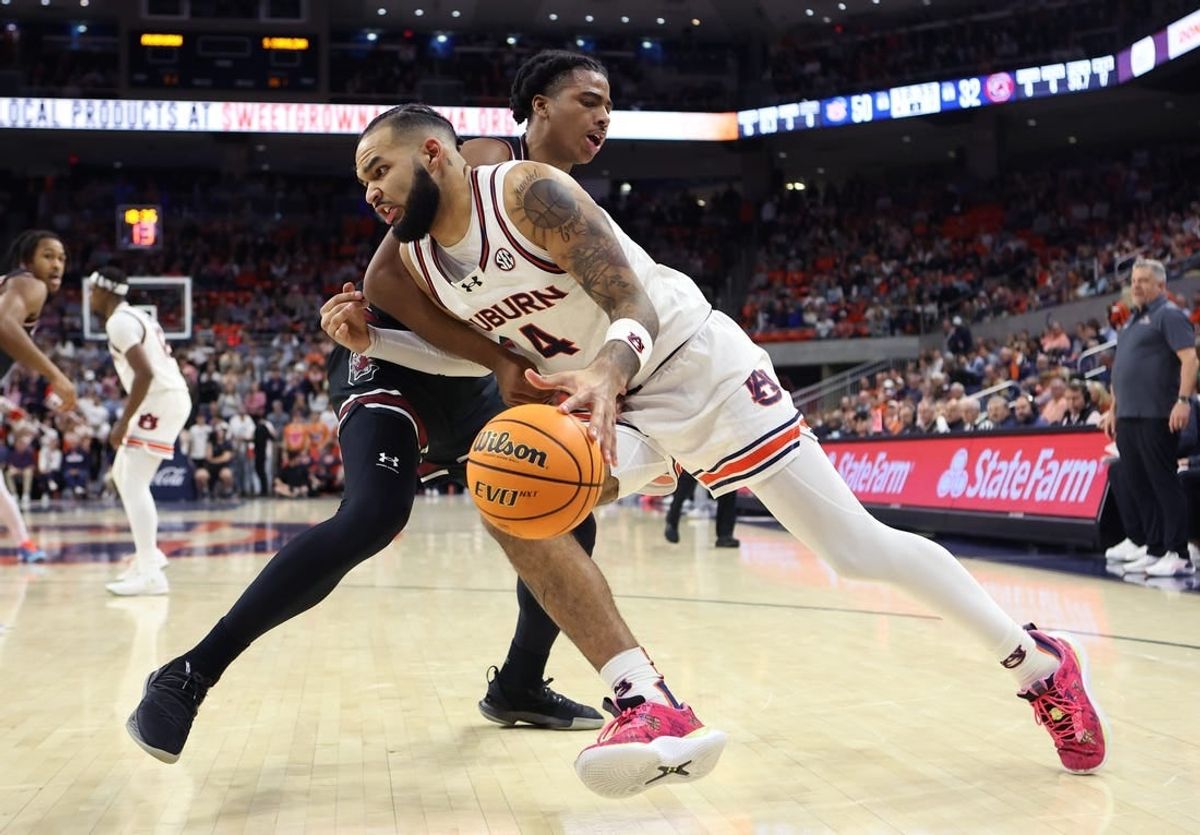 Feb 14, 2024; Auburn, Alabama, USA; South Carolina Gamecocks forward Collin Murray-Boyles (30) fouls Auburn Tigers forward Johni Broome (4) during the second half at Neville Arena.