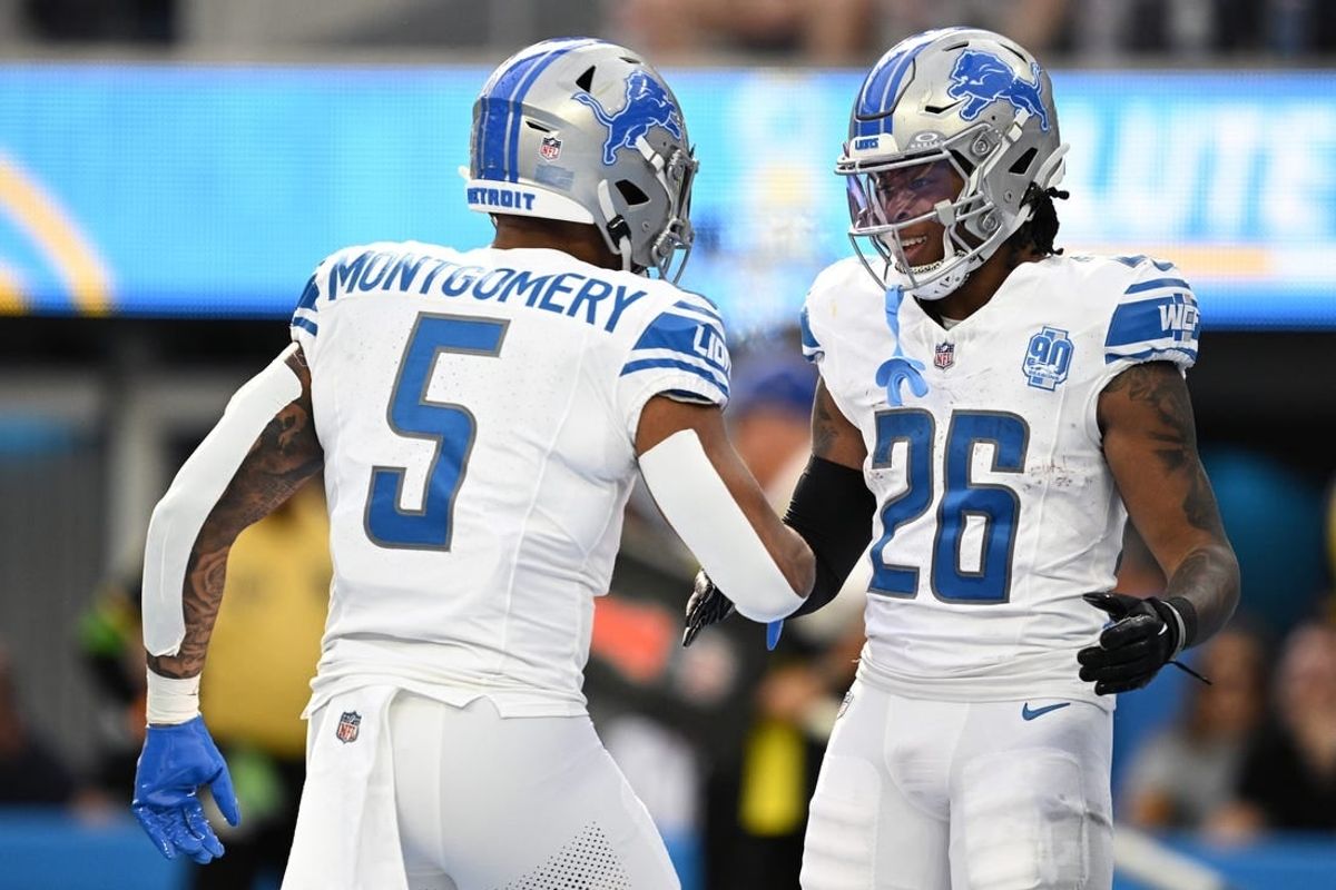 Detroit Lions running back Jahmyr Gibbs (26) celebrates with running back David Montgomery (5) after scoring a touchdown against the Los Angeles Chargers during the first half at SoFi Stadium.