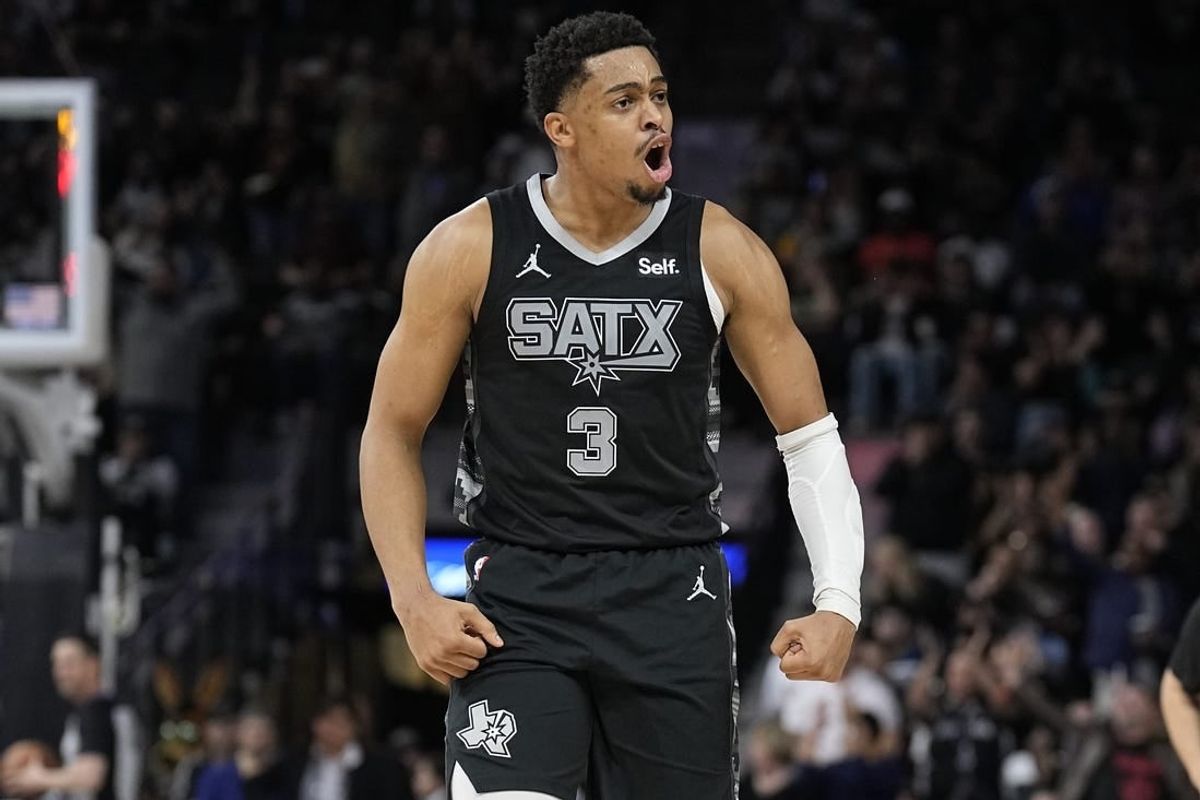 Jan 27, 2024; San Antonio, Texas, USA; San Antonio Spurs forward Keldon Johnson (3) reacts after scoring a three point basket during the second half against the Minnesota Timberwolves at Frost Bank Center.