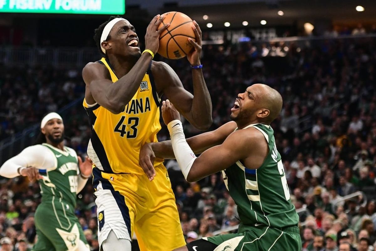 Apr 21, 2024; Milwaukee, Wisconsin, USA; Indiana Pacers forward Pascal Siakam (43) takes a shot against Milwaukee Bucks forward Khris Middleton (22) in the fourth quarter during game one of the first round for the 2024 NBA playoffs at Fiserv Forum.