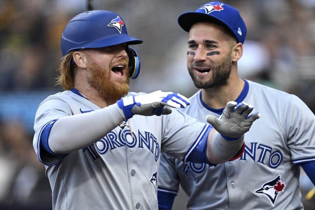 Apr 19, 2024; San Diego, California, USA; Toronto Blue Jays designated hitter Justin Turner (left) is congratulated by center fielder Kevin Kiermaier (right) after hitting a home run against the San Diego Padres during the first inning at Petco Park.