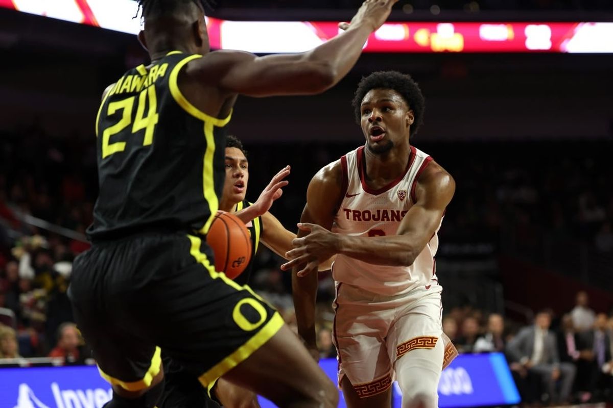Feb 1, 2024; Los Angeles, California, USA; USC Trojans guard Bronny James (6) passes the ball against Oregon Ducks forward Mahamadou Diawara (24) during the first half at Galen Center.