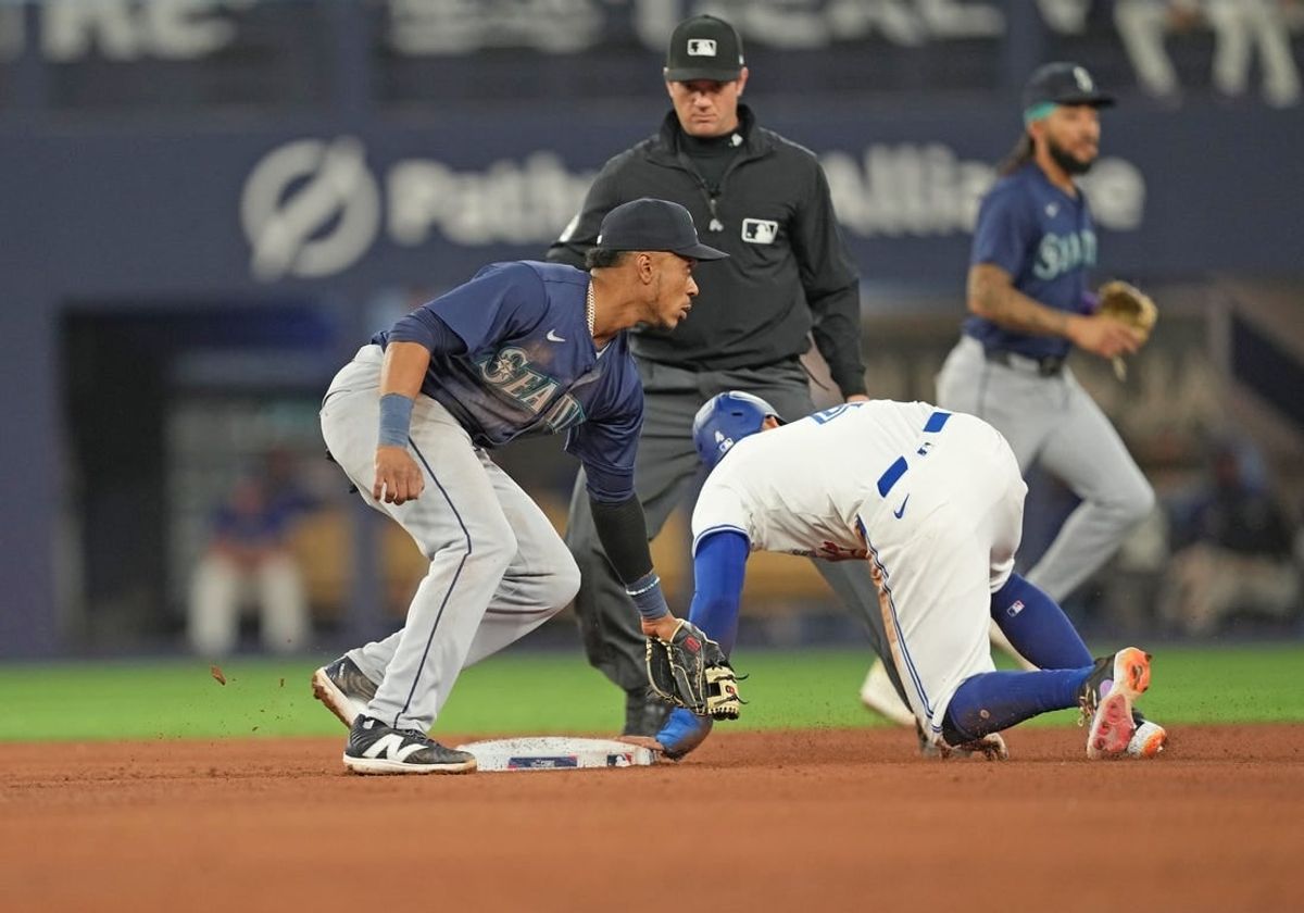 Apr 9, 2024; Toronto, Ontario, CAN; Toronto Blue Jays right fielder George Springer (4) steals second base ahead of the tag from Seattle Mariners second baseman Jorge Polanco (7) during the fourth inning at Rogers Centre.