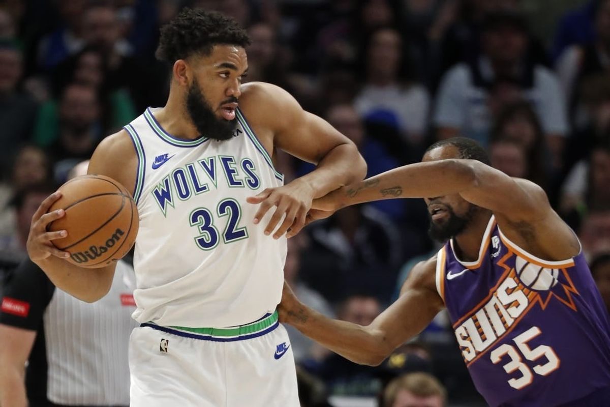 Apr 14, 2024; Minneapolis, Minnesota, USA; Minnesota Timberwolves forward Karl-Anthony Towns (32) works against the defense of Phoenix Suns forward Kevin Durant (35) in the first quarter at Target Center.