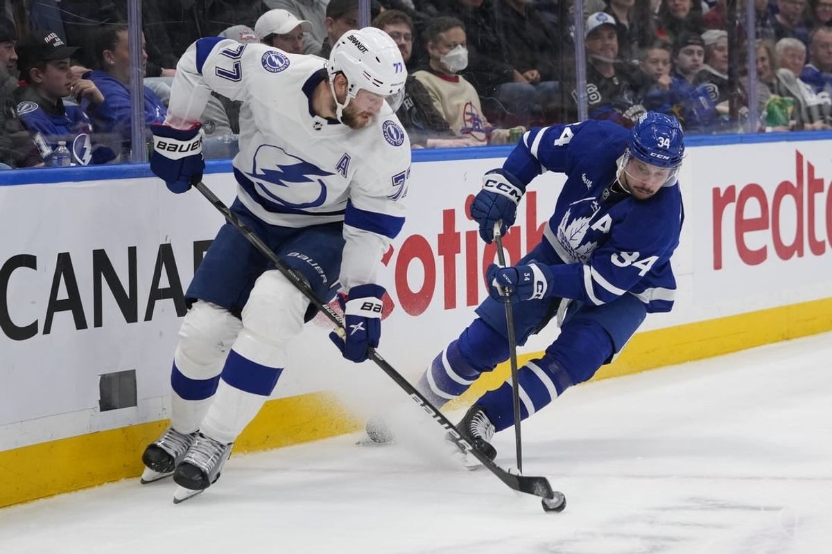 Apr 3, 2024; Toronto, Ontario, CAN; Tampa Bay Lightning defenseman Victor Hedman (77) and Toronto Maple Leafs forward Auston Matthews (34) battle for the puck during the second period at Scotiabank Arena.